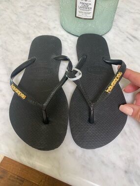 Havaianas Black Flip Flops with Gold Logo Accent